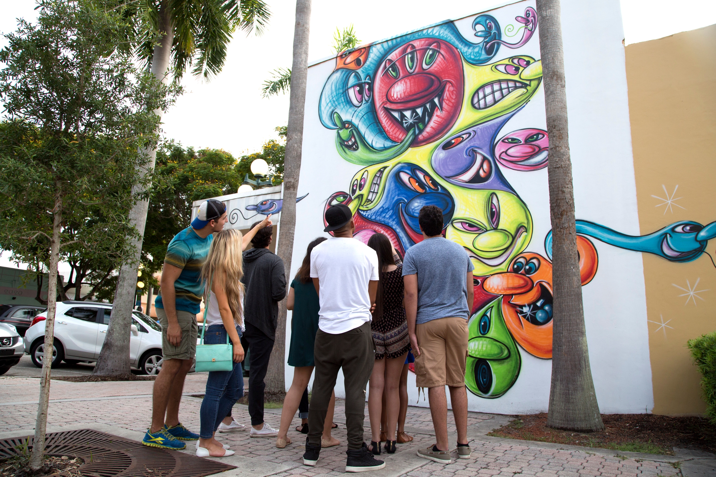 Group admires mural.