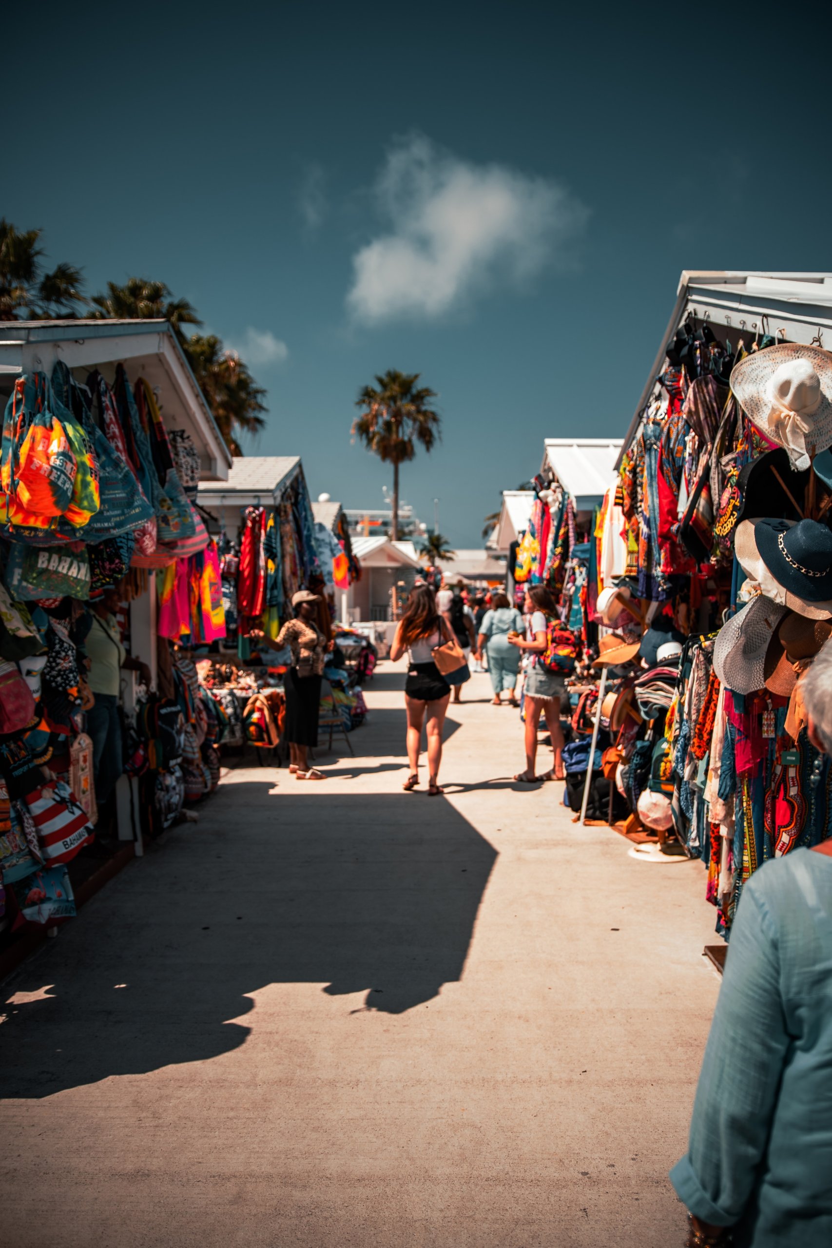 Woman walks along vendor booths.