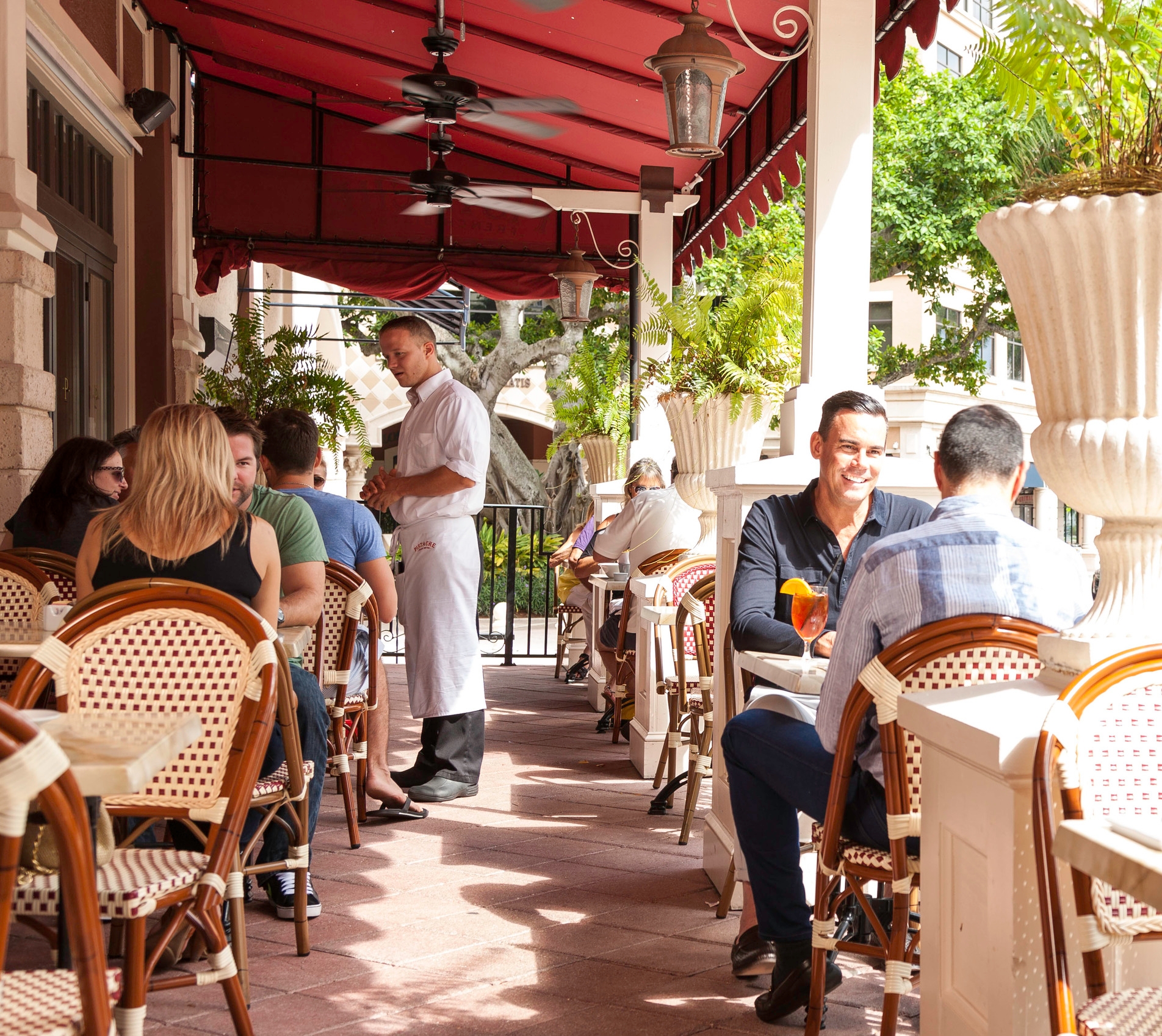 Sunny day on a busy restaurant patio.